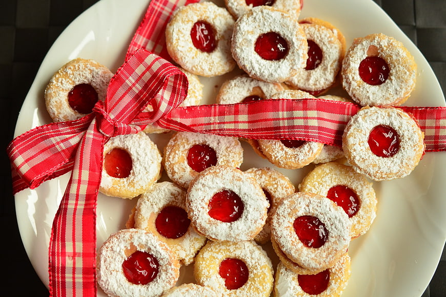 Christmas Linzer Cookies With Red Ribbon On White Plate