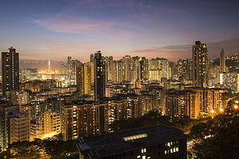 Hong Kong City Skyline at Dusk with Illuminated Skyscrapers