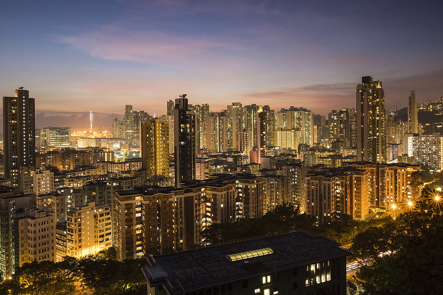 Hong Kong City Skyline at Dusk with Illuminated Skyscrapers