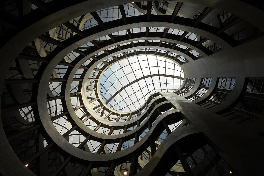 Low angle view of modern spiral staircase with glass dome ceiling