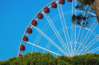 Red Ferris Wheel Against Blue Sky
