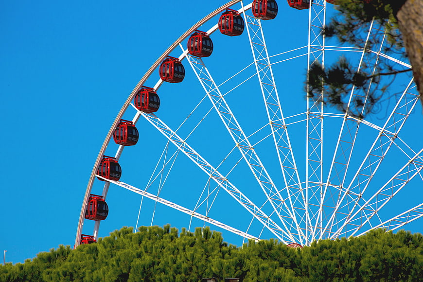 Red Ferris Wheel Against Blue Sky