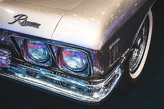 Close-up of vintage beige Chrysler Imperial front bumper and headlights