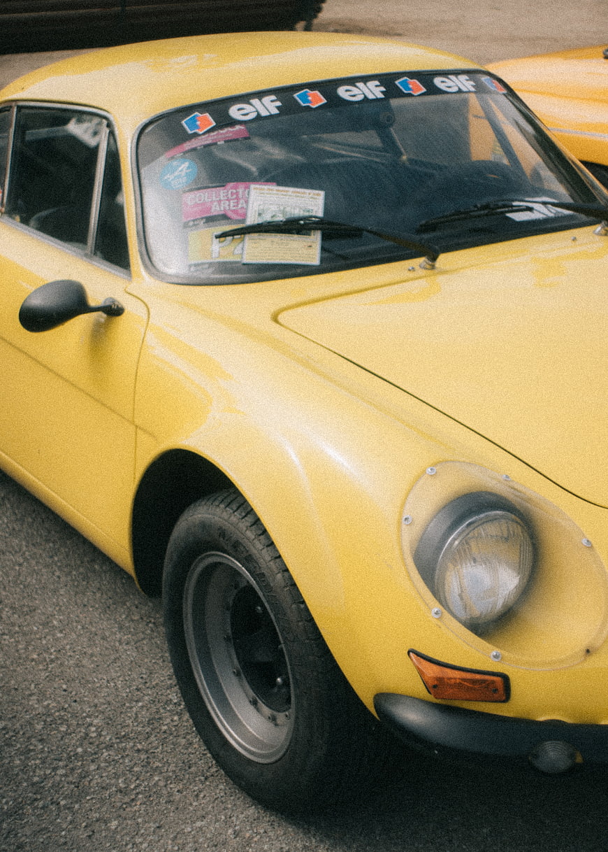 Yellow vintage Porsche 911 race car with Elf stickers