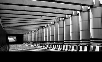 Black and White Concrete Tunnel with Rhythmic Pillars