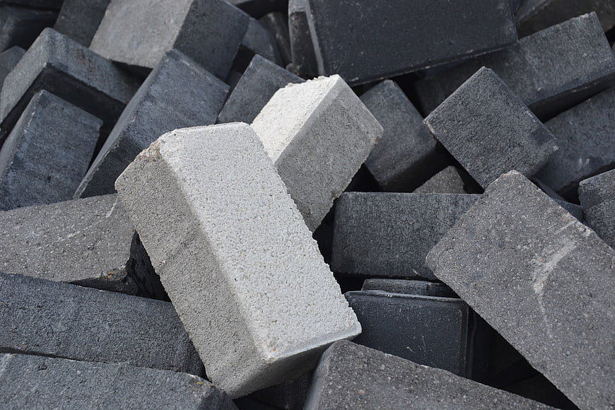 Pile of gray concrete blocks and masonry bricks