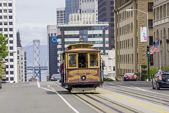 San Francisco Cable Car Descending Steep Hill with Bay Bridge