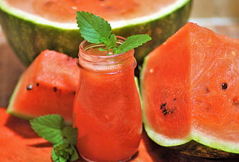 Fresh watermelon juice in glass bottle with mint garnish