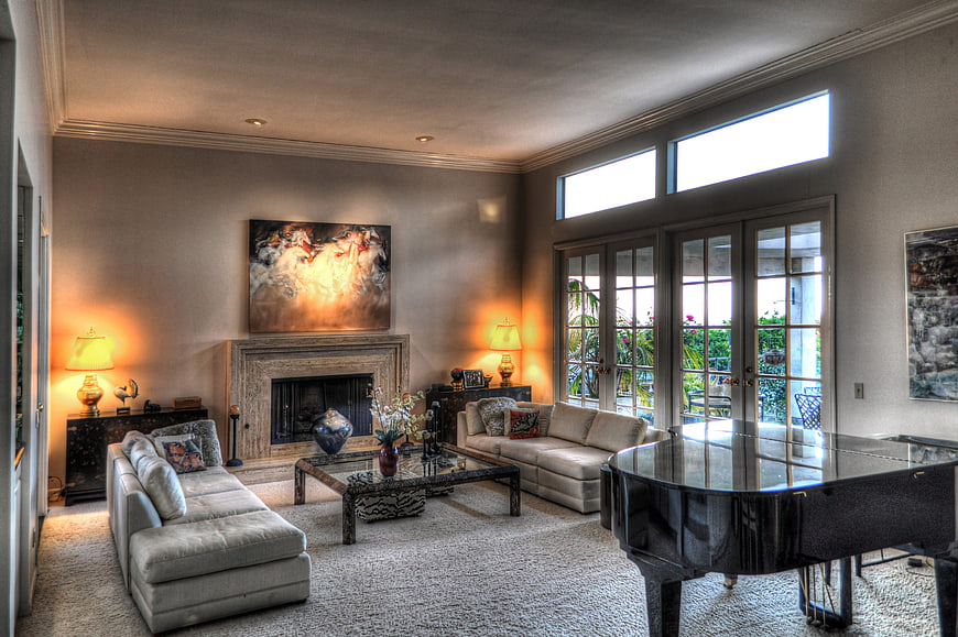 Luxurious living room with grand piano and fireplace