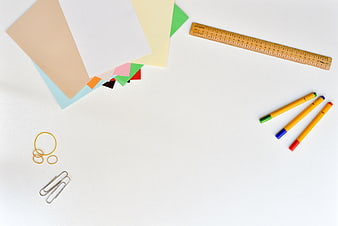 Flat lay of colorful office supplies on white background