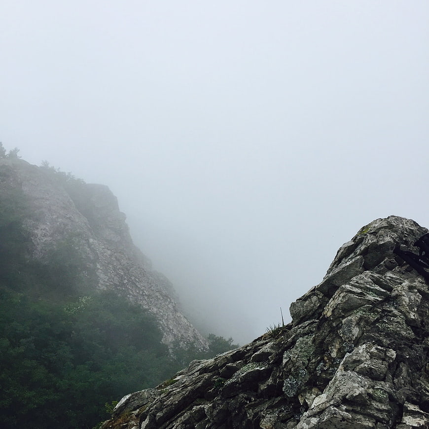 Misty Mountain Ridge with Rocky Outcrop and Foggy Valley