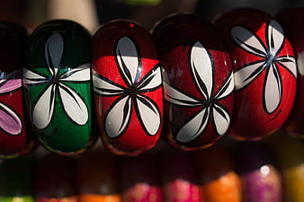 Close-up of colorful hand-painted wooden beads with floral patterns