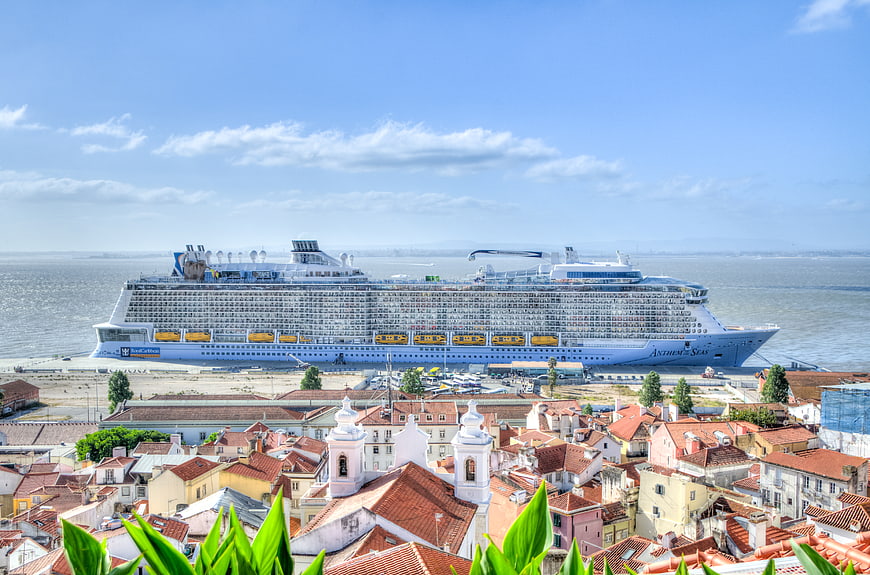 Cruise ship docked in Lisbon harbor with city rooftops