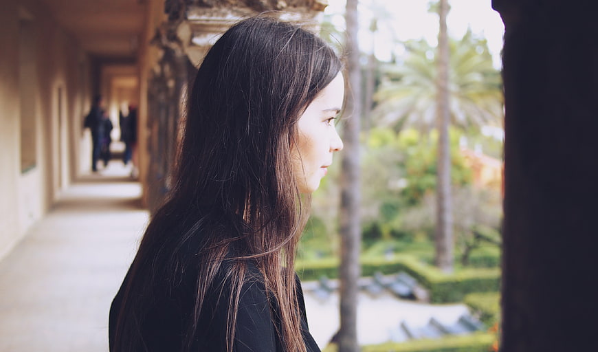Profile of Brunette Woman Looking Out at Garden