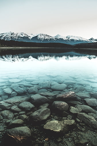 Serene Mountain Lake with Clear Rocky Shore and Reflections