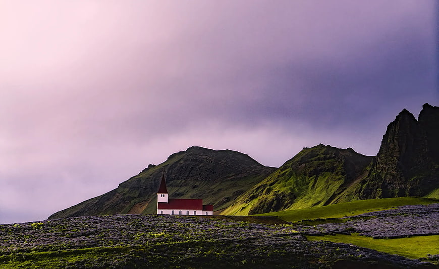 White Church with Red Roof in Green Mountain Landscape