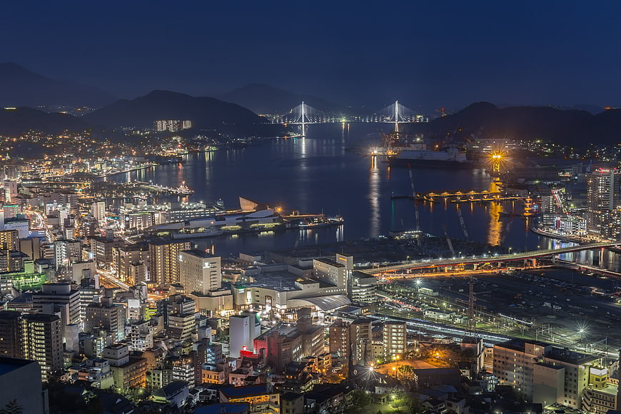 Nagasaki City Night View With Illuminated Harbor And Bridge