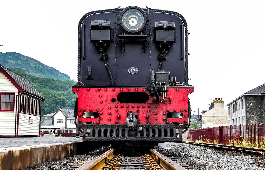 Front view of vintage steam locomotive at railway station