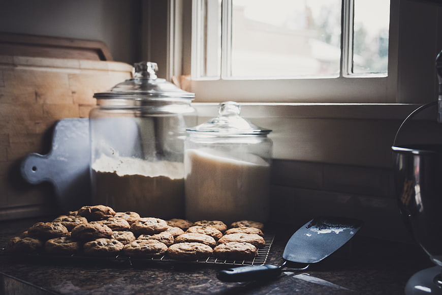 Fresh Baked Cookies on Kitchen Counter with Flour and Sugar Jars