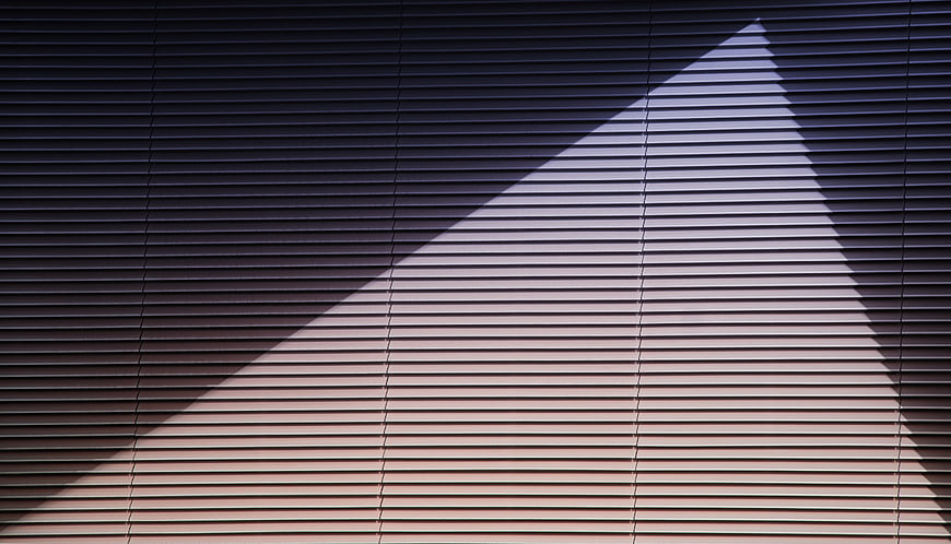 Geometric shadow pattern on horizontal window blinds