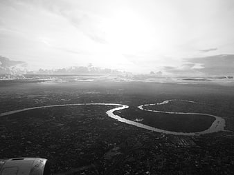 Aerial black and white view of winding river from airplane