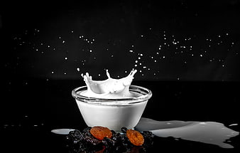 Yogurt Splash with Raisins and Apricots on Black Background