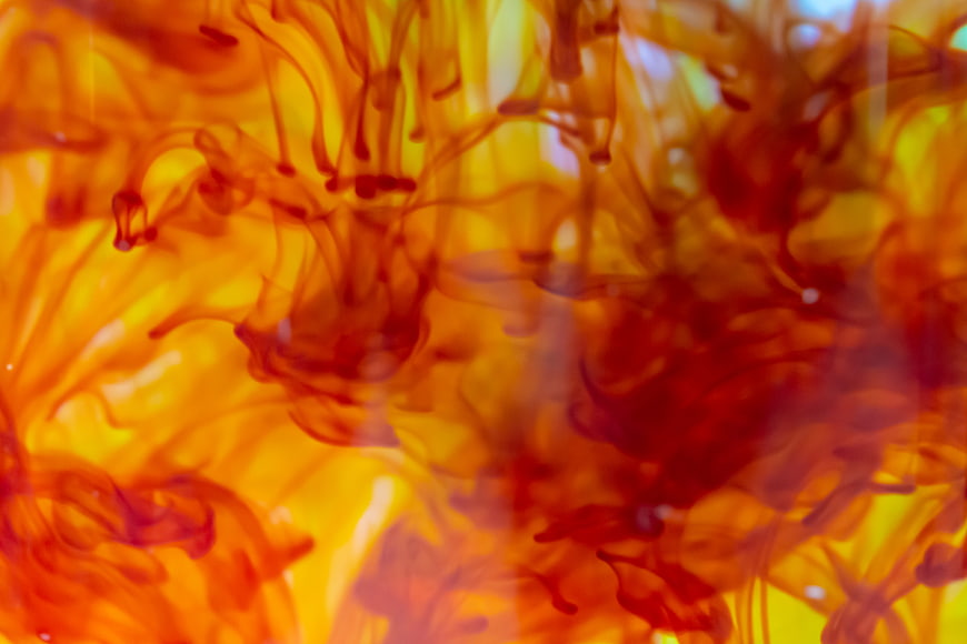 Abstract Red and Yellow Ink Swirling in Water