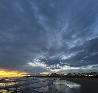 Dramatic Stormy Sunset Over Coastal City Skyline