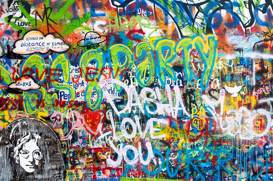 Vibrant multicolored graffiti wall with layered street art and text