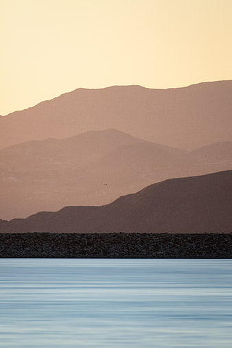 Serene Mountain Landscape with Calm Water at Sunset