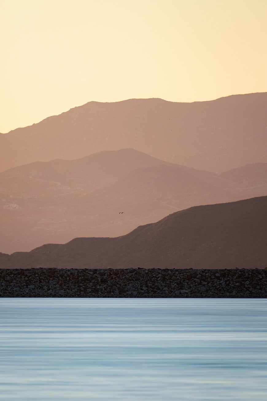 Serene Mountain Landscape with Calm Water at Sunset