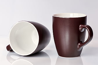 Two Brown Ceramic Coffee Mugs Isolated on White Background