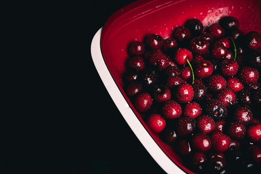 Fresh Red Cherries in Bowl on Black Background