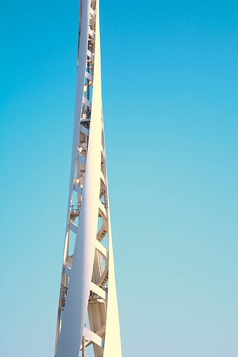 White steel tower structure against clear blue sky