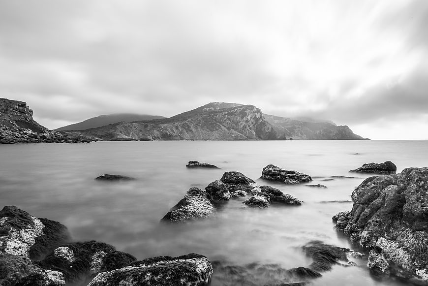 Black and white long exposure coastal landscape with rocks