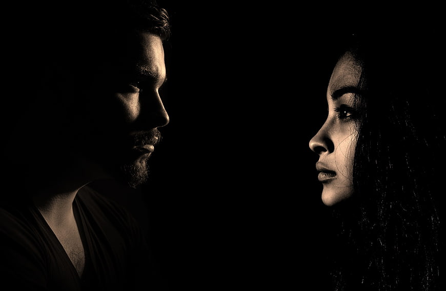 Dramatic Sepia Portrait of Man and Woman Facing Each Other