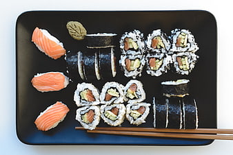 Top view of assorted sushi platter on black tray
