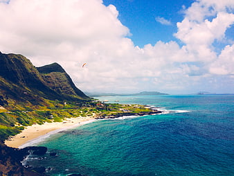 Aerial View of Green Mountains and Turquoise Ocean Coastline