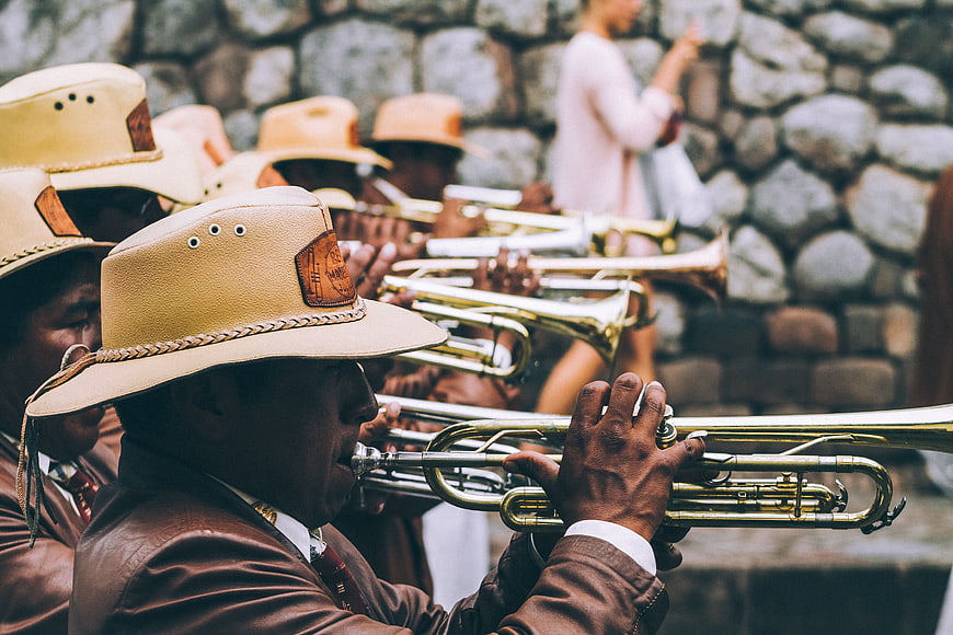 Musicians playing trumpets in traditional hats