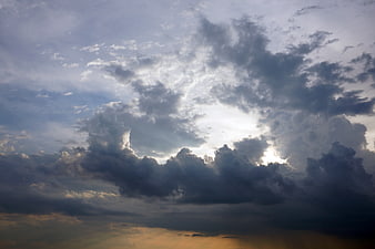 Dramatic Storm Clouds with Sun Rays Breaking Through at Sunset