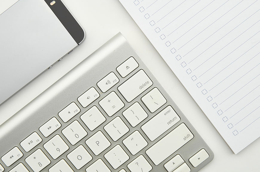 Minimalist Office Desk with Keyboard, Smartphone, and Notepad