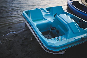 Blue Pedal Boat on Sandy Lake Shore