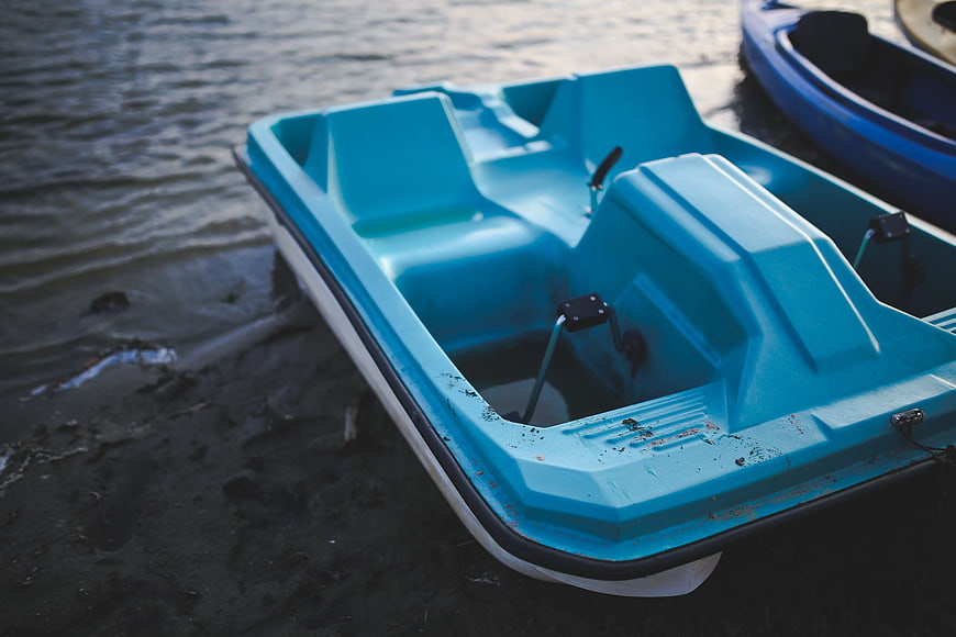 Blue Pedal Boat on Sandy Lake Shore