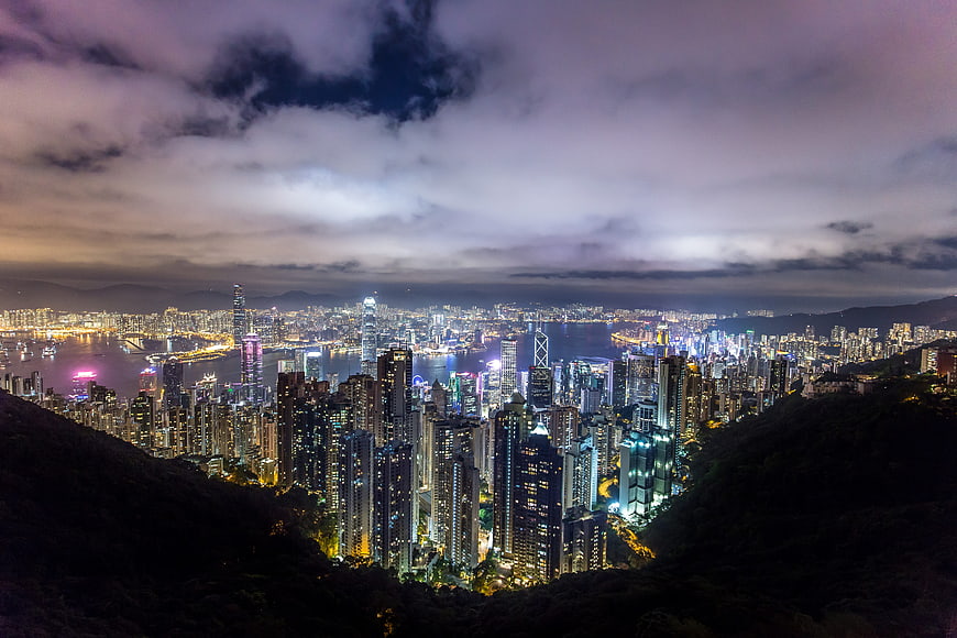 Hong Kong Cityscape at Night with Dramatic Clouds and Skyscrapers