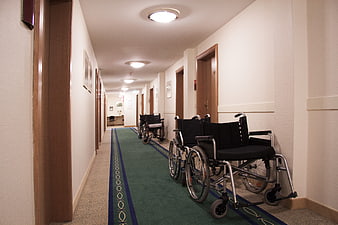 Empty hospital corridor with wheelchairs lined up against wall