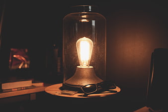 Vintage Edison Bulb Lamp with Sunglasses on Wooden Table