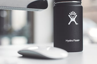 Black Hydro Flask water bottle on office desk