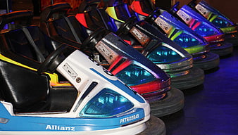Colorful bumper cars lined up at night fairground