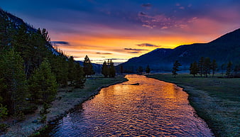 Vibrant Sunset Reflections on a Winding Mountain River