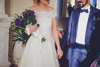 Bride and Groom Holding Hands with Purple Bouquet
